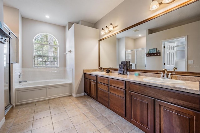 5109 Hartwell Loop, Land O Lakes, FL 34638 - bathroom featuring tile patterned floors, a stall shower, a garden tub, double vanity, and baseboards
