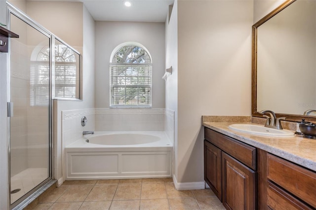 5109 Hartwell Loop, Land O Lakes, FL 34638 - full bathroom with a stall shower, a garden tub, tile patterned floors, and vanity