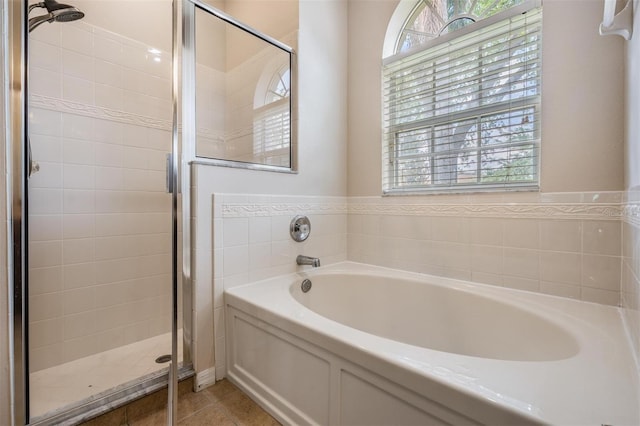 5109 Hartwell Loop, Land O Lakes, FL 34638 - bathroom featuring healthy amount of natural light, a stall shower, a garden tub, and tile patterned flooring