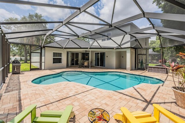 5109 Hartwell Loop, Land O Lakes, FL 34638 - outdoor pool with a patio, a grill, a ceiling fan, and glass enclosure