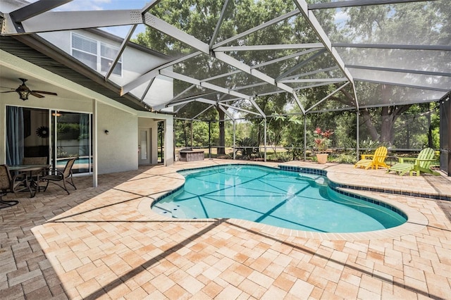 5109 Hartwell Loop, Land O Lakes, FL 34638 - outdoor pool with a patio area, a hot tub, glass enclosure, and a ceiling fan