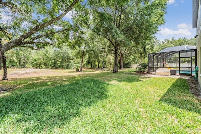 5109 Hartwell Loop, Land O Lakes, FL 34638 - view of grassy yard with a pool and glass enclosure