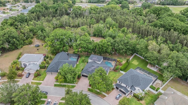 5109 Hartwell Loop, Land O Lakes, FL 34638 - aerial view of property and surrounding area featuring nearby suburban area and a heavily wooded area