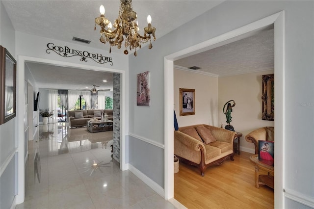 2219 Summit View Dr, Valrico, FL 33596 - hall featuring baseboards, a chandelier, and a textured ceiling