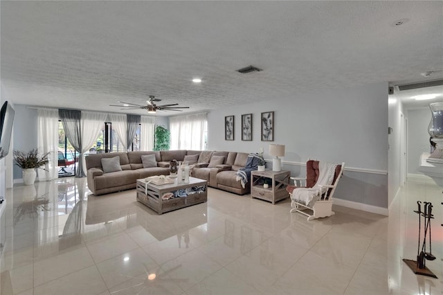 2219 Summit View Dr, Valrico, FL 33596 - living room featuring healthy amount of natural light, a textured ceiling, tile patterned floors, ceiling fan, and baseboards