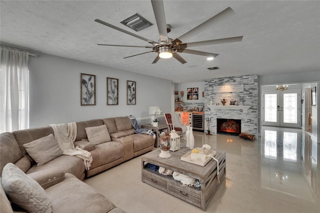 2219 Summit View Dr, Valrico, FL 33596 - living area featuring a textured ceiling, a ceiling fan, light tile patterned floors, a chandelier, and french doors