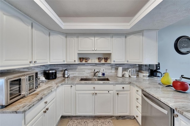 2219 Summit View Dr, Valrico, FL 33596 - kitchen featuring a sink, stainless steel dishwasher, a raised ceiling, white cabinets, and light stone counters