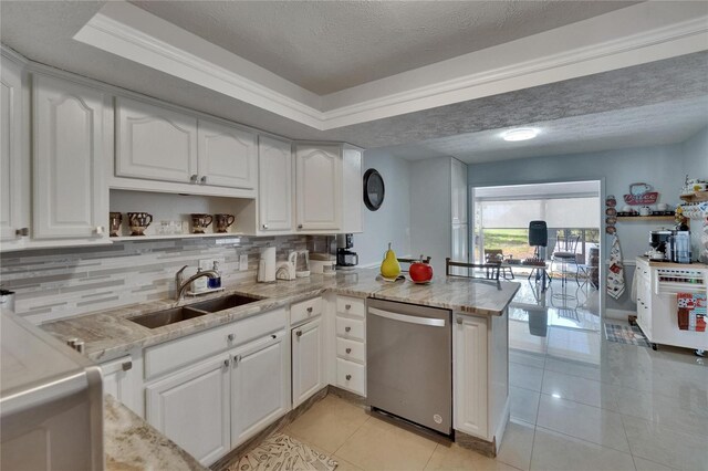 2219 Summit View Dr, Valrico, FL 33596 - kitchen featuring stainless steel dishwasher, a sink, light tile patterned flooring, a peninsula, and white cabinetry
