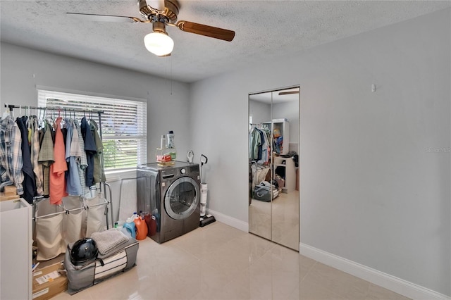 2219 Summit View Dr, Valrico, FL 33596 - clothes washing area with a textured ceiling, washer / clothes dryer, ceiling fan, baseboards, and tile patterned floors