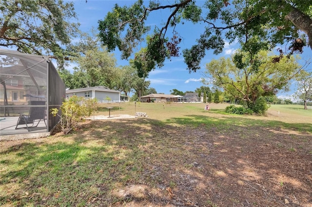 2219 Summit View Dr, Valrico, FL 33596 - view of grassy yard featuring a lanai