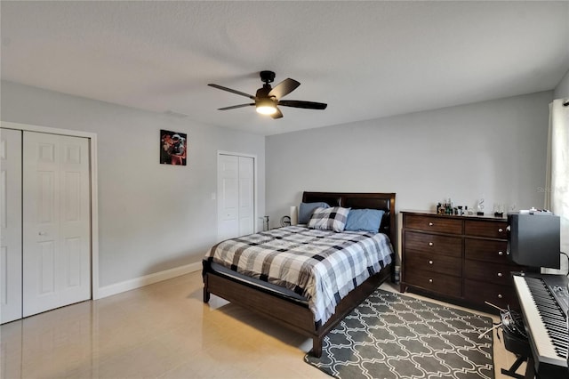 2219 Summit View Dr, Valrico, FL 33596 - bedroom with two closets, baseboards, and ceiling fan