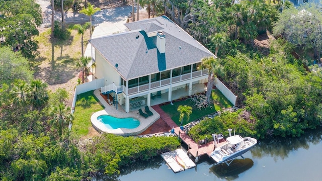 view of subject property with a large body of water and a pool area