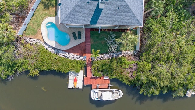 aerial view of property and surrounding area with a nearby body of water and a pool