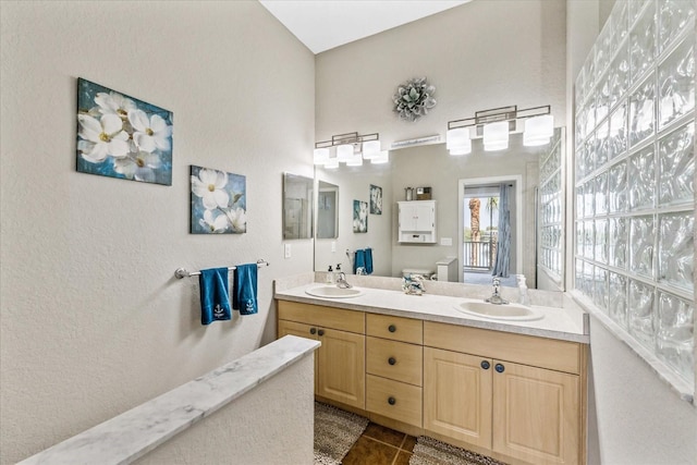 bathroom featuring tile patterned floors and double vanity