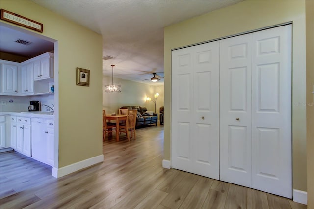 2913 Fig Ct, Palm Harbor, FL 34684 - hallway with light wood-style floors and baseboards