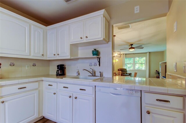 2913 Fig Ct, Palm Harbor, FL 34684 - kitchen featuring dishwasher, a sink, ceiling fan, and tasteful backsplash