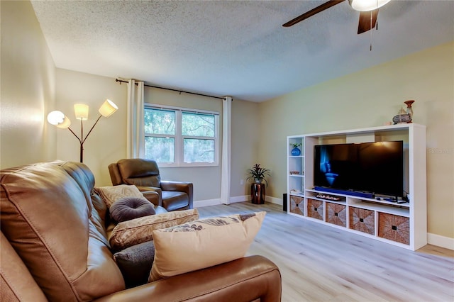 2913 Fig Ct, Palm Harbor, FL 34684 - living area featuring wood finished floors, a ceiling fan, a textured ceiling, and baseboards