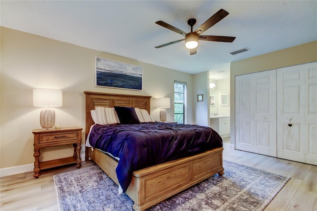 2913 Fig Ct, Palm Harbor, FL 34684 - bedroom with light wood-type flooring, ensuite bathroom, baseboards, a closet, and ceiling fan