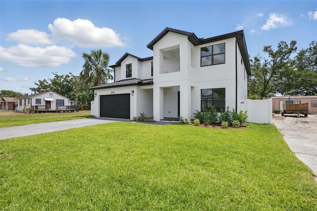 view of front facade featuring stucco siding, driveway, and a garage