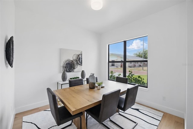 dining room featuring baseboards and light wood-style floors