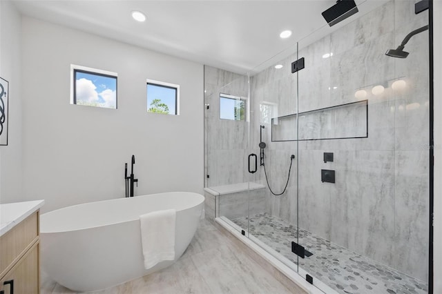 bathroom with a soaking tub, a stall shower, vanity, recessed lighting, and marble finish floors