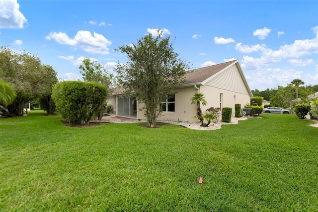 2015 W Del Webb Blvd, Sun City Center, FL 33573 - back of house featuring a yard and stucco siding