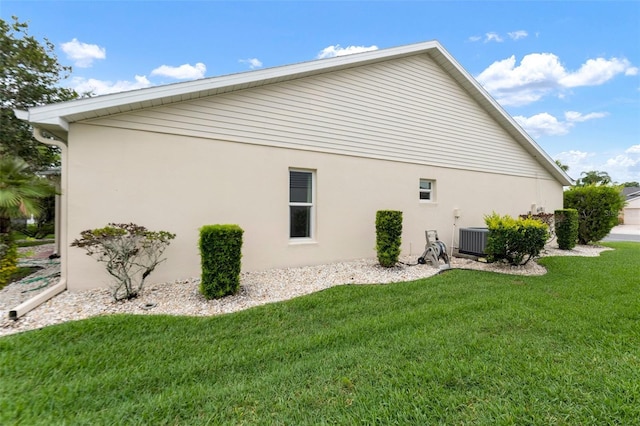 2015 W Del Webb Blvd, Sun City Center, FL 33573 - view of home's exterior featuring a yard, stucco siding, and cooling unit