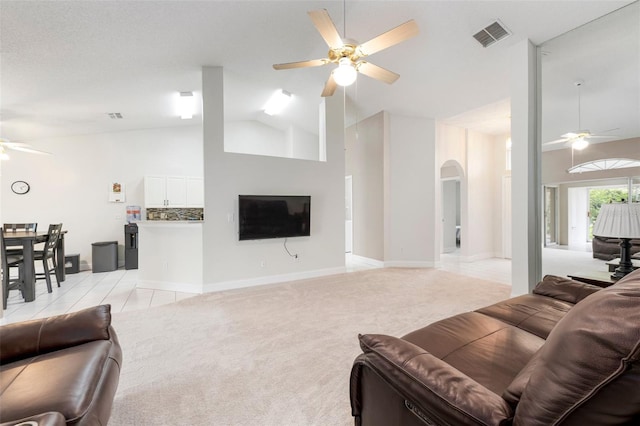 2015 W Del Webb Blvd, Sun City Center, FL 33573 - living area with a ceiling fan, arched walkways, light colored carpet, light tile patterned floors, and high vaulted ceiling