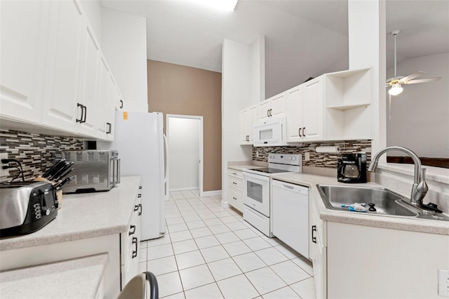 2015 W Del Webb Blvd, Sun City Center, FL 33573 - kitchen with white appliances, a sink, a ceiling fan, open shelves, and backsplash