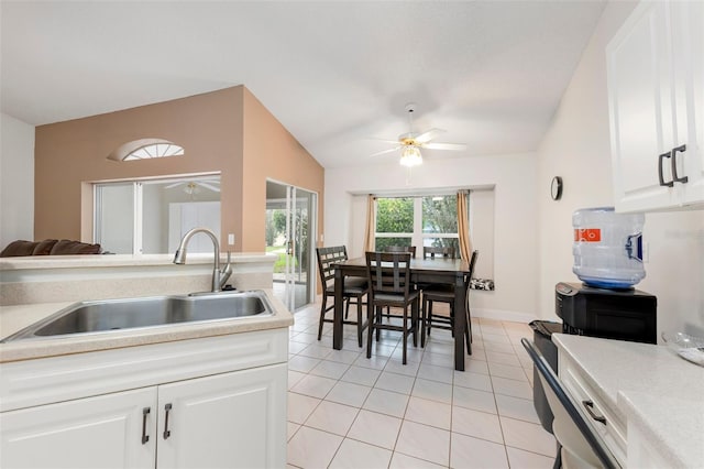 2015 W Del Webb Blvd, Sun City Center, FL 33573 - kitchen featuring a sink, light tile patterned flooring, a ceiling fan, light countertops, and white cabinetry