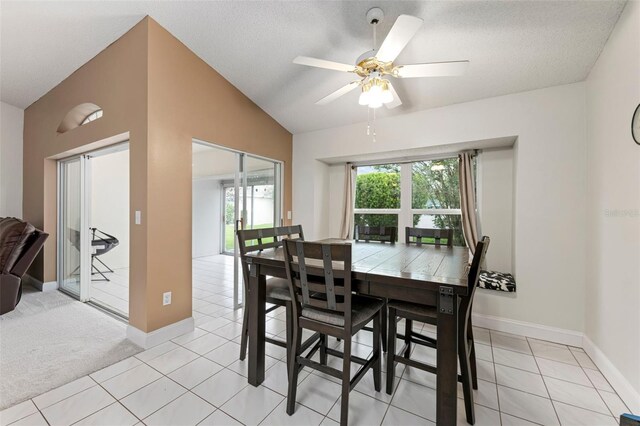 2015 W Del Webb Blvd, Sun City Center, FL 33573 - dining room with light tile patterned floors, lofted ceiling, baseboards, and ceiling fan