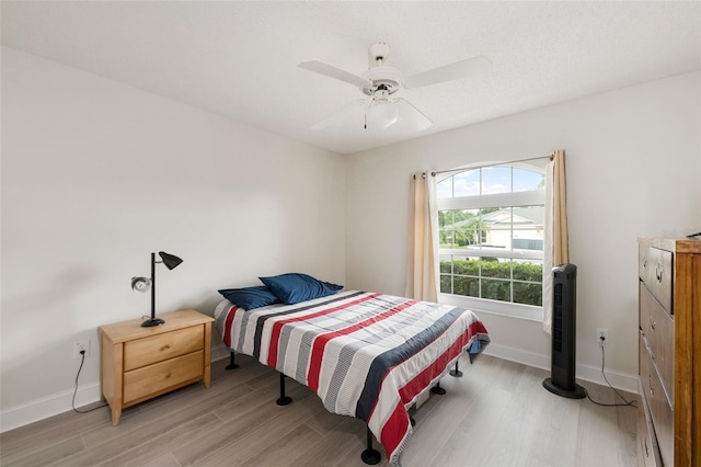 2015 W Del Webb Blvd, Sun City Center, FL 33573 - bedroom with light wood-style flooring, baseboards, and ceiling fan