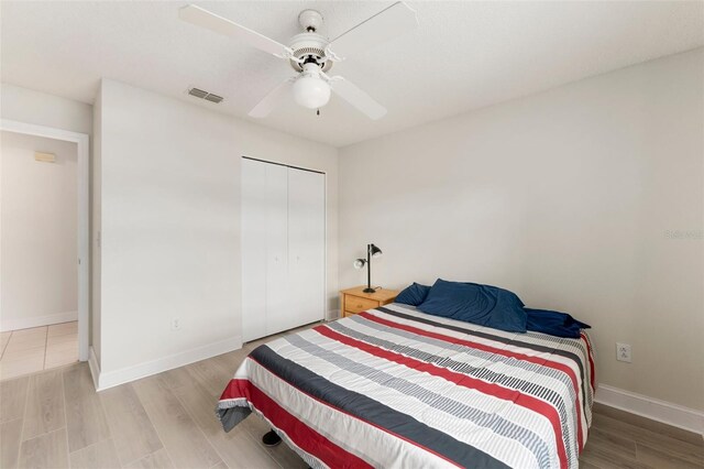 2015 W Del Webb Blvd, Sun City Center, FL 33573 - bedroom featuring wood finished floors, a closet, baseboards, and ceiling fan