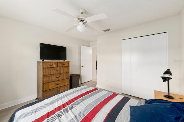 2015 W Del Webb Blvd, Sun City Center, FL 33573 - bedroom with baseboards, a closet, wood finished floors, and a ceiling fan