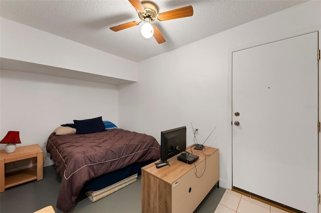 2015 W Del Webb Blvd, Sun City Center, FL 33573 - bedroom with a textured ceiling, a ceiling fan, and light tile patterned floors