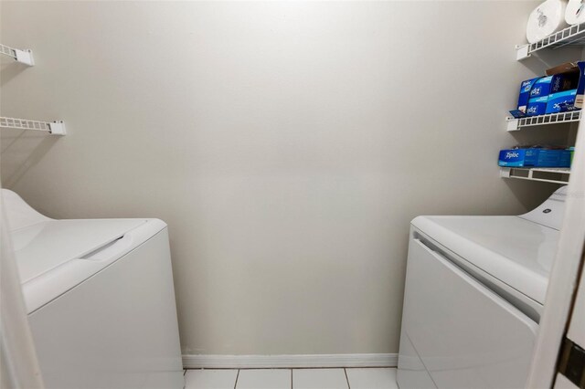 2015 W Del Webb Blvd, Sun City Center, FL 33573 - laundry room featuring separate washer and dryer, baseboards, and tile patterned flooring