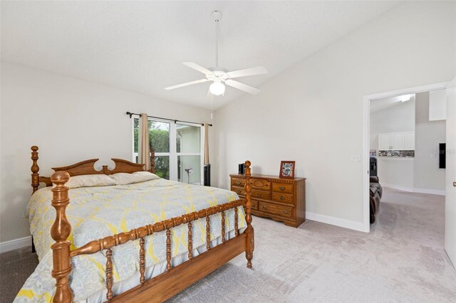 2015 W Del Webb Blvd, Sun City Center, FL 33573 - bedroom with baseboards, light colored carpet, lofted ceiling, a ceiling fan, and a walk in closet
