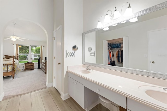 2015 W Del Webb Blvd, Sun City Center, FL 33573 - full bathroom with double vanity, wood finished floors, a spacious closet, ceiling fan, and ensuite bathroom