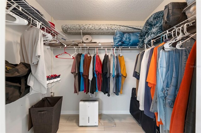 2015 W Del Webb Blvd, Sun City Center, FL 33573 - walk in closet featuring tile patterned flooring