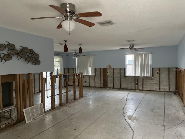 1500 Ohio Ave NE, Saint Petersburg, FL 33703 - unfurnished room featuring plenty of natural light, ceiling fan, and unfinished concrete floors