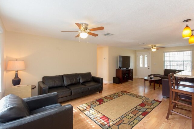 1500 Ohio Ave NE, Saint Petersburg, FL 33703 - living room featuring a ceiling fan, light wood-style flooring, and baseboards