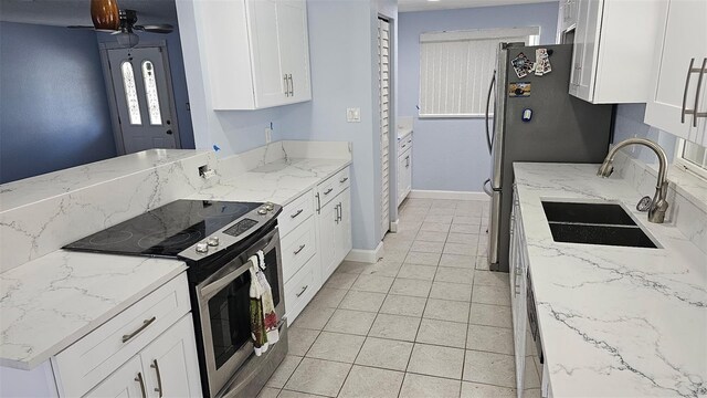1500 Ohio Ave NE, Saint Petersburg, FL 33703 - kitchen featuring appliances with stainless steel finishes, a sink, white cabinets, a ceiling fan, and baseboards
