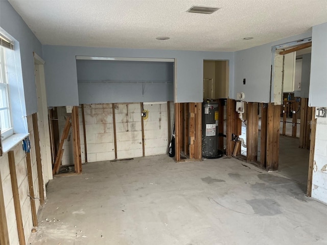 1500 Ohio Ave NE, Saint Petersburg, FL 33703 - interior space with water heater and a textured ceiling