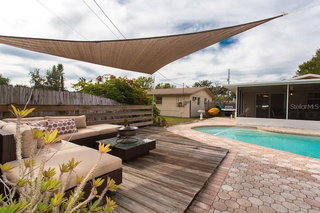 1500 Ohio Ave NE, Saint Petersburg, FL 33703 - view of swimming pool with a sunroom, fence, a deck, an outdoor hangout area, and an outdoor structure