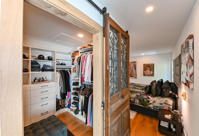 13916 Wellesford Way, Tampa, FL 33624 - walk in closet featuring wood finished floors and attic access