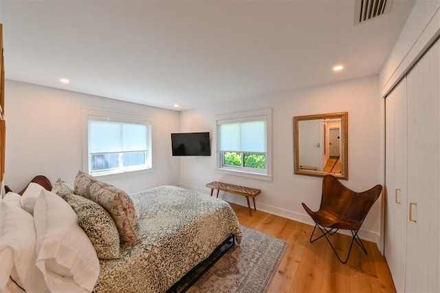 13916 Wellesford Way, Tampa, FL 33624 - bedroom with light wood-style floors, a closet, recessed lighting, and baseboards