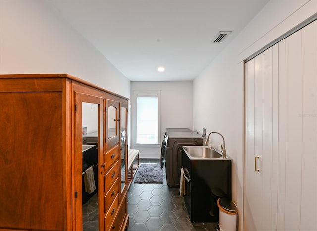 13916 Wellesford Way, Tampa, FL 33624 - laundry room featuring washer hookup, dark tile patterned flooring, and recessed lighting