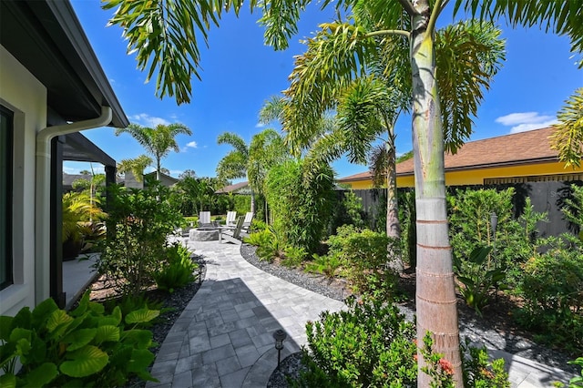 13916 Wellesford Way, Tampa, FL 33624 - view of property's community featuring a patio, a fire pit, and a fenced backyard