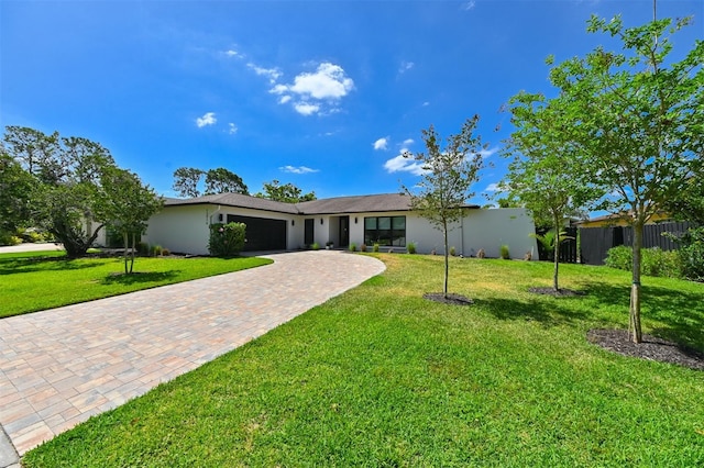 13916 Wellesford Way, Tampa, FL 33624 - view of front facade with an attached garage, decorative driveway, and stucco siding