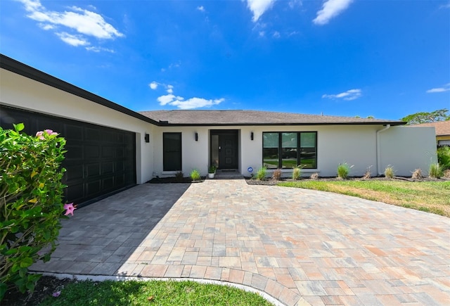 13916 Wellesford Way, Tampa, FL 33624 - ranch-style home featuring stucco siding, a garage, and decorative driveway